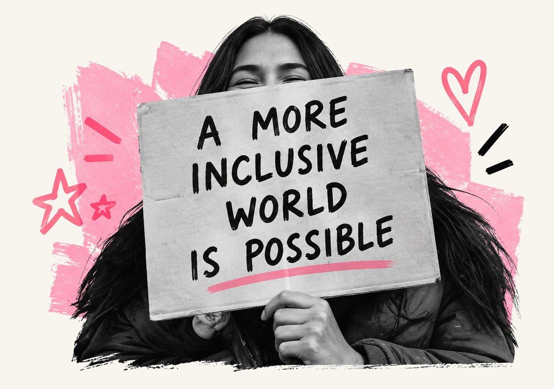 Woman holding a sign that reads a more inclusive world is possible