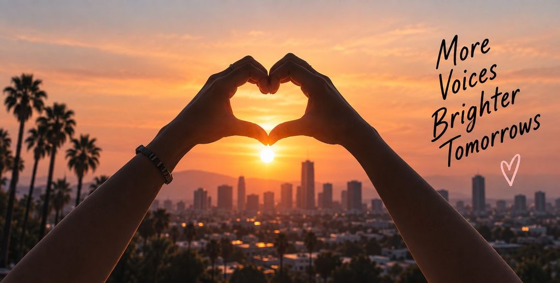 Hands making a heart shape against a sunset